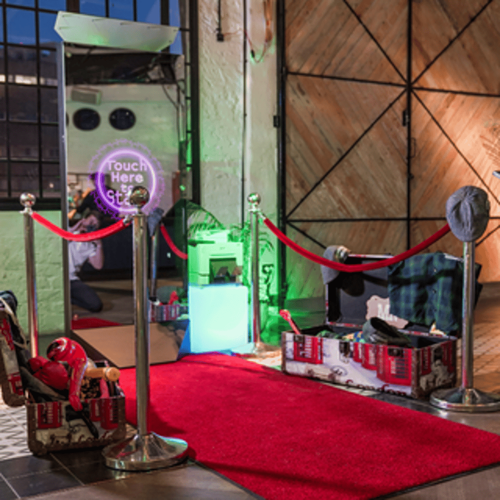 Mirror Booth elegant red carpet set-up. Showing the mirror booth  with a red carpet rolled out silver stanchions with red velvet ropes.